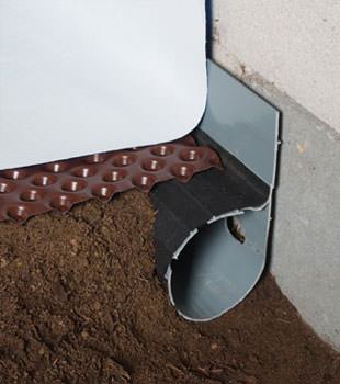 Closeup of a crawl space drainage system installed in Manassas