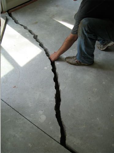 a severely damaged cracked concrete slab floor in Gainsville