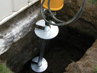 Installing a helical pier system in the earth around a foundation in Gaithersburg