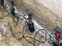 Using foundation push piers to lift a foundation during a repair in Silver Spring.