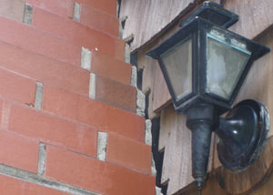 A tilting chimney in Springfield showing serious foundation damage.