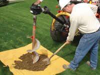 Auguring a hole in the earth for a foundation wall repair system in Gainesville
